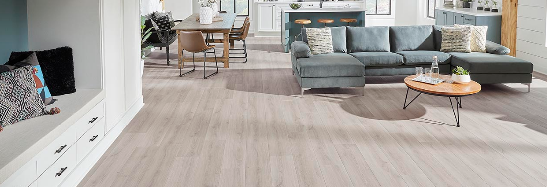 Mohawk luxury vinyl plank flooring is featured prominently in a living room with an open floor plan.