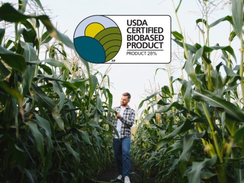 Man picking corn in a corn field used for SmartStrand carpet fibers